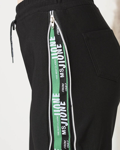 Royalfashion Czarne damskie spodnie dresowe z zielonymi lampasami