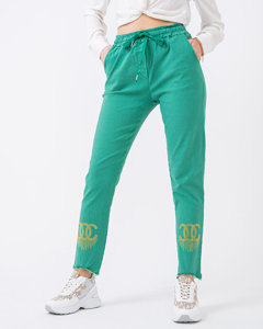 Зелені тканинні жіночі штани з фіанітами - Одяг