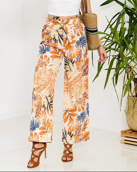 Жіночі біло-помаранчеві брюки палаццо з квітковим візерунком - Одяг